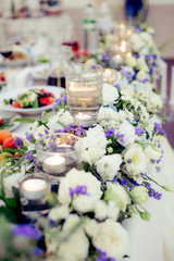flowers on the wedding table table decoration flowers design floristics blue and white tablecloth glasses