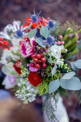 bridal bouquet of bride is given by the groom beautiful of flowers of blue lilac pink red white roses and flowers