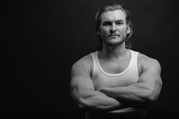 black and white shot. bearded guy is having thews of steel. pump iron concept