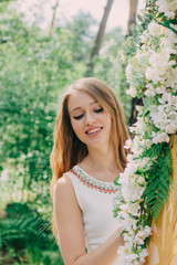 Very beautiful woman in nature surrounded by real flowers.