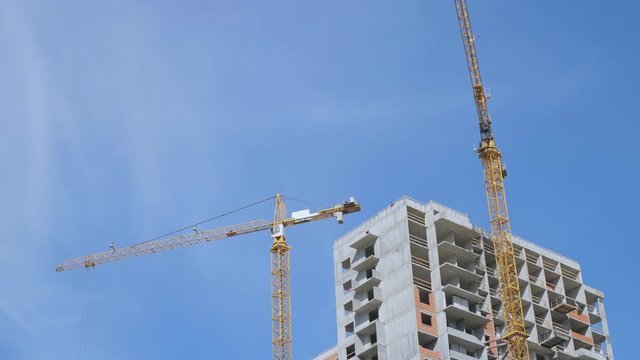 Cranes on blue sky background