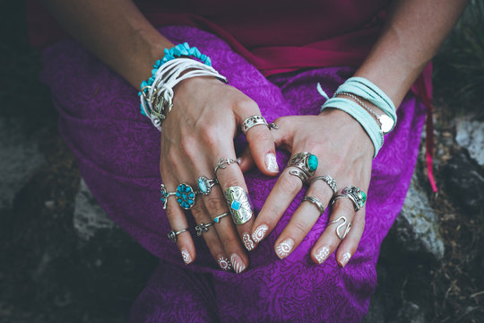 close up of young woman hands with boho accessories rings and bracelets