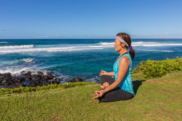 Fototapeta na wymiar Woman Practicing Yoga on the Maui Coast