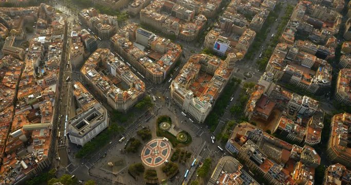 Aerial view of Placa de Catalunya in Barcelona with typical urban grid, Spain. Late afternoon light