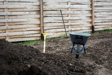 Garden wheelbarrow, shovel and humus.