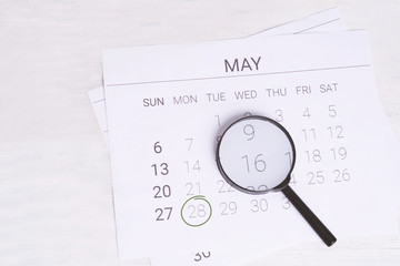 May Calendar with Magnifying glass.
