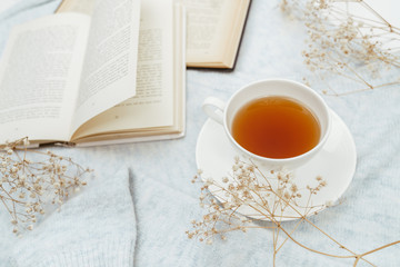 Warm knitted sweater,cup of hot tea and book