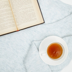 Warm knitted sweater,cup of hot tea and book