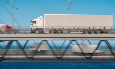 Side View of a White Semi Trailer Truck over the Bridge