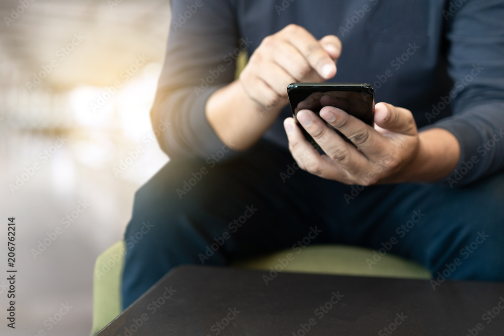 Poster man using smart phone on and reading message in coffee shop