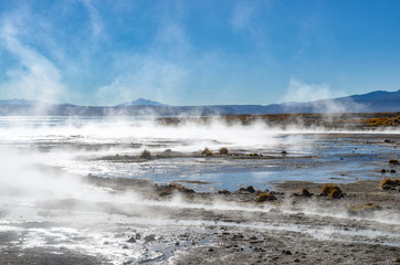 Uyuni, Bolivia - Sept 10, 2015: Tourists relaxing in the volcanic Aguas Calientes hot springs in the Reserva Eduardo Avaroa