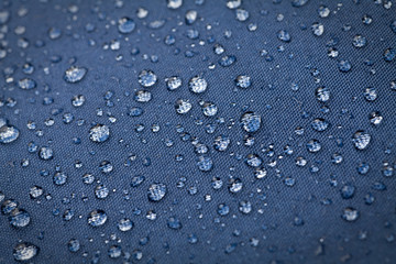 Drops of water on blue waterproof cloth