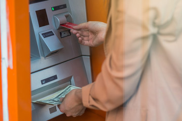 woman withdrawing the cash via ATM, business Automatic Teller Machine concept