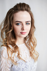 Portrait of a beautiful young woman in evening dress. Girl with make-up and hairstyle