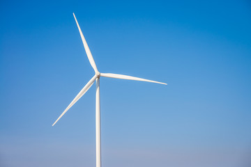 Wind turbines generating electricity with blue sky