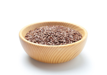 Flax seeds in a wooden bowl on white background