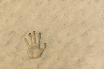 The hand print on mud ground after water receded