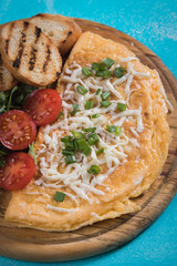 Omelet, fried chicken eggs with fresh vegetables