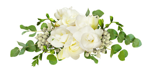 Fresh white freesia flowers and eucalyptus leaves in arrangement