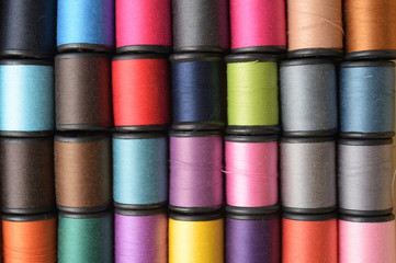 close up of colorful thread spools for background