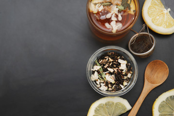 Glass Cup of Herbal Tea with Acacia Flowers and honey on Black Background, top view, Copy space. Health Drink Coldness