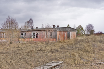 Old abandoned one-storey wooden log house in russian village