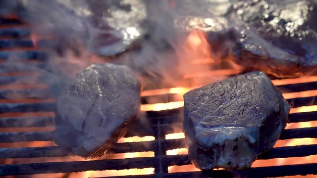 Extreme closeup of filet mignon on a fiery hot grill.