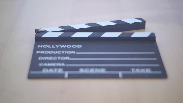 Push In Shot of a clapperboard lying on a table.