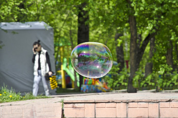 Flight of soap bubble in the park. They are up in the air