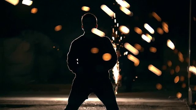 Night tricking, man jumps and makes a kick in the air with his foot