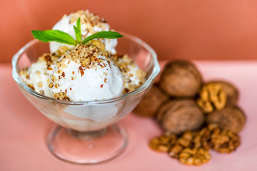 Vanilla ice cream in bowl and walnuts