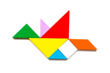 Color wood tangram puzzle in flying bird shape on white background