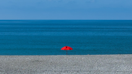 red umbrella in the beach