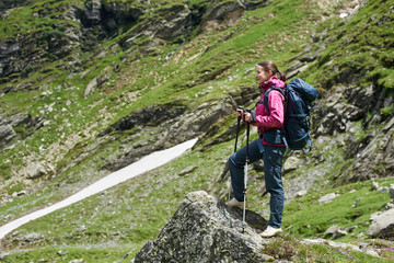 Young woman hiker resting in the mountains while hiking copyspace enjoyment positivity emotions happiness sport lifestyle active living backpacking trekking exploring wilderness travelling.