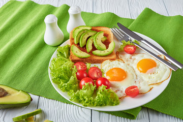 eggs, fresh salad, toast with yeast spread