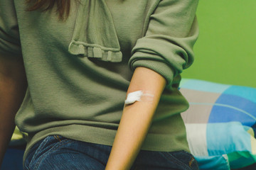 The nurse takes the patient's blood with a syringe.