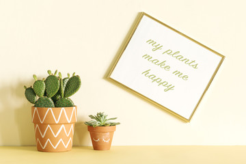 Modern yellow interior with cactus in hipster clay pot with gold mock up frame. 