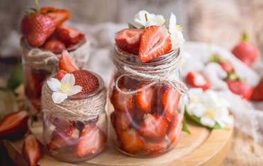 Fresh strawberries in jars