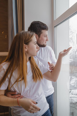Lovely couple have fun and relax at home near window