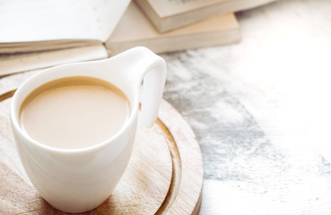 a cup of coffee with books