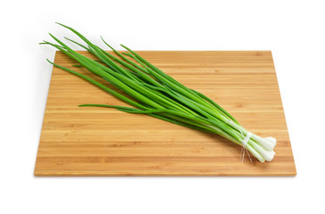 Bunch of green onion on the bamboo cutting board