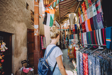 Back view of young female traveller at traditional bazaar in Dubai, UAE