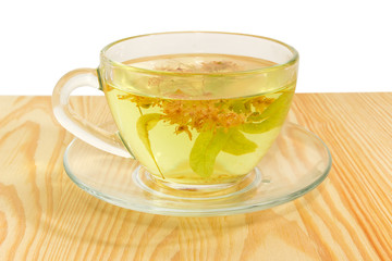 Linden flower tea in transparent glass cup closeup