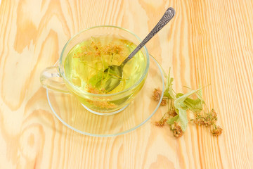 Linden flower tea in glass cup and dried linden flowers
