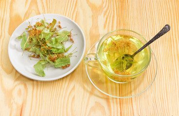Linden flower tea in glass cup and dried linden flowers