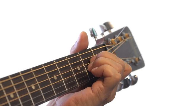 Close up mens fingers playing music on acoustic guitar
