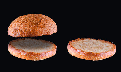 Grilled burger bun isolated on black background. Close up.