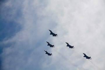 Naklejka na ściany i meble Five military aircraft flying in the sky
