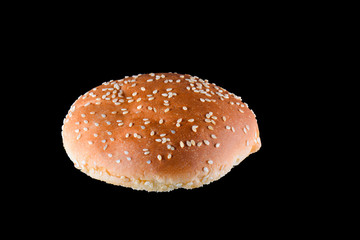 Grilled burger bun isolated on black background. Close up
