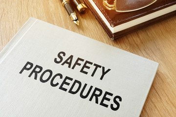 Safety procedures manual on an office desk. - obrazy, fototapety, plakaty